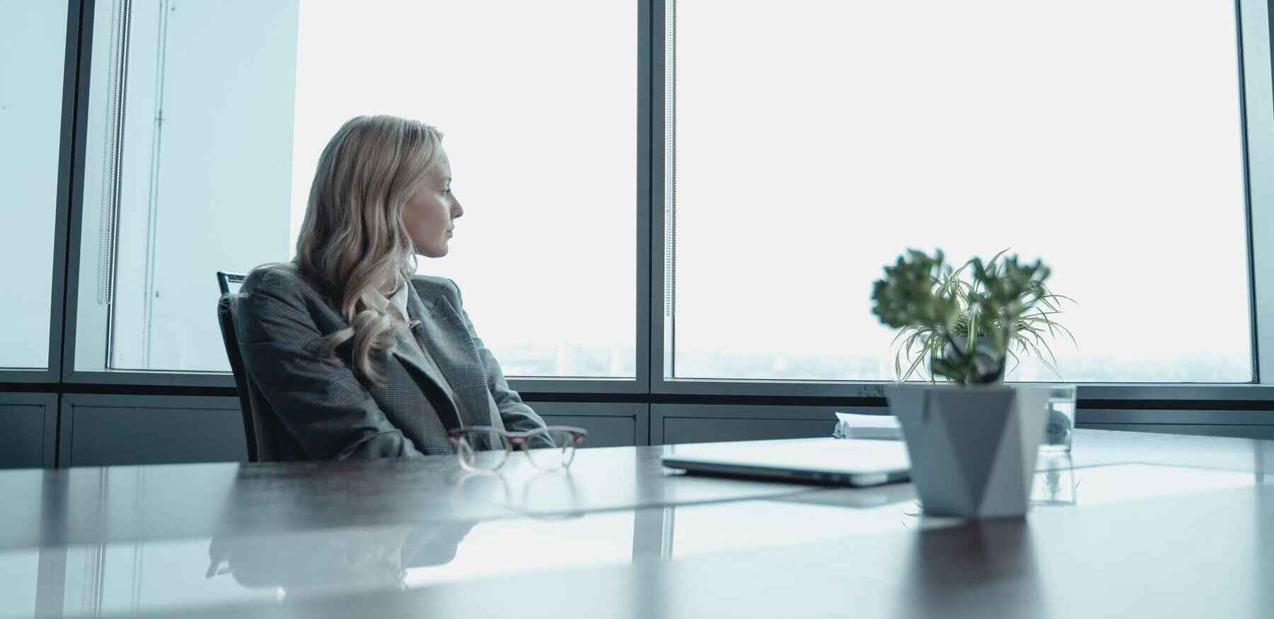 woman looking at the window in a conference room