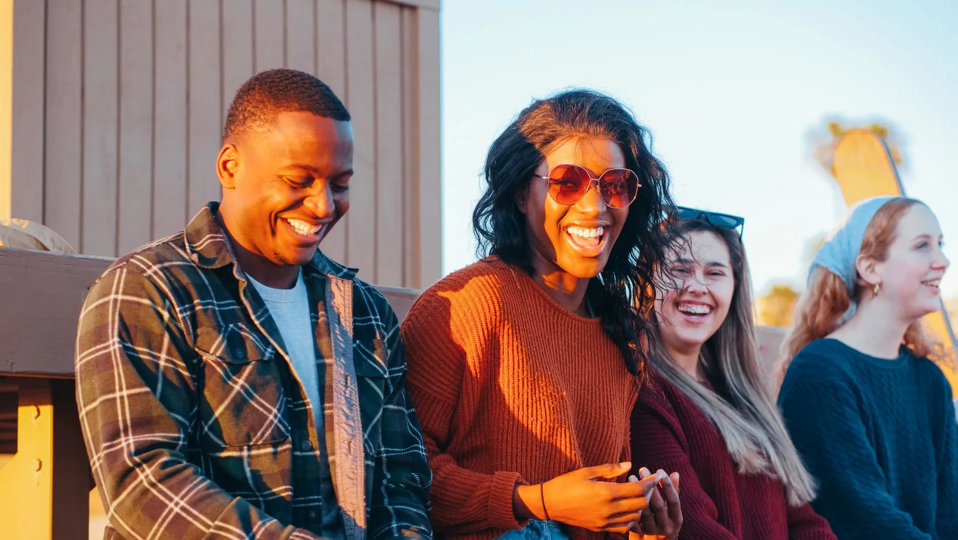 group of friends socializing outside at sunset