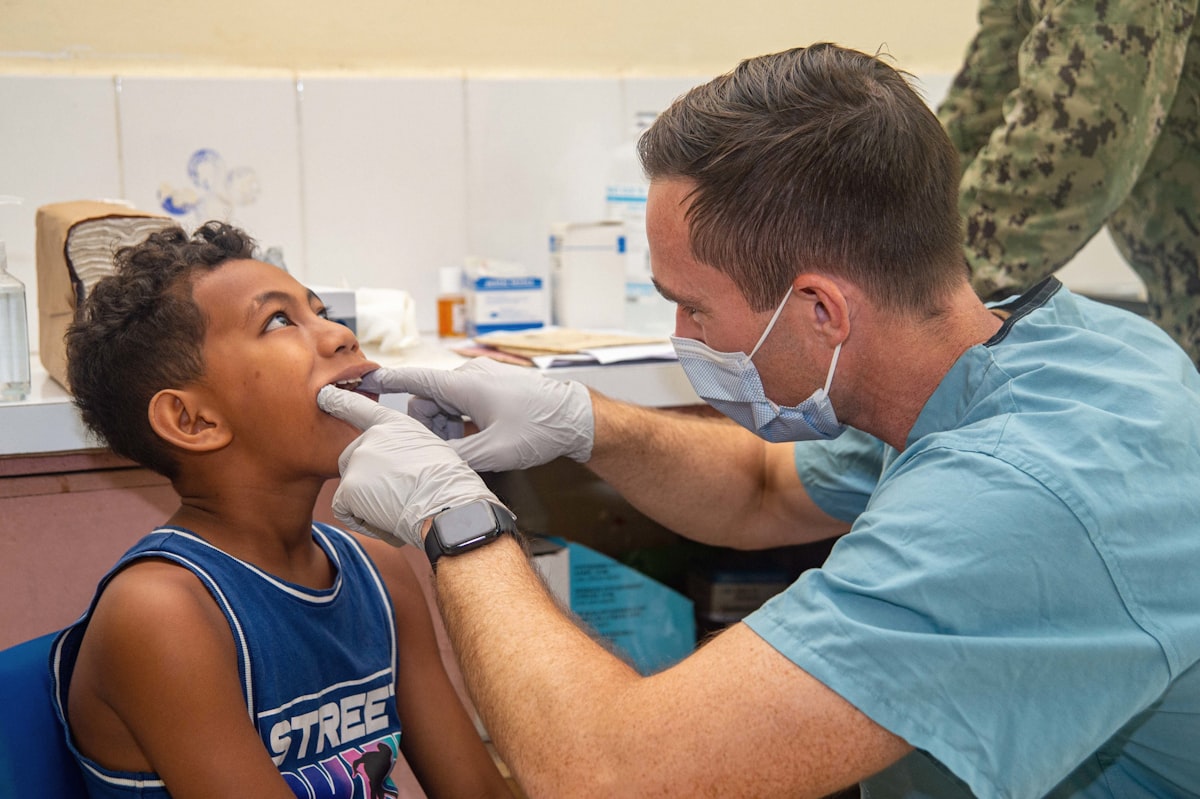 Dentist examining a young patient during a family dental checkup