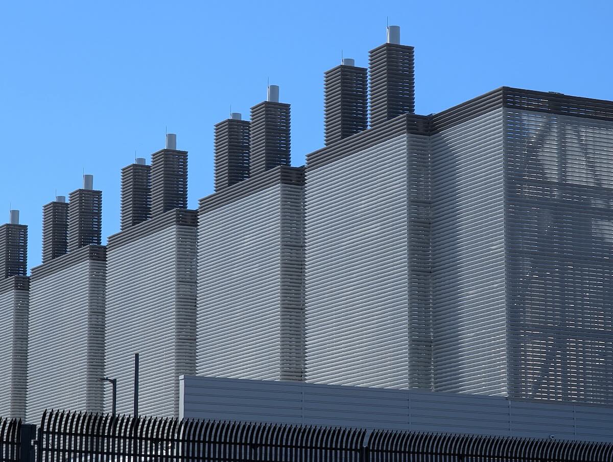 Data center facility in Virginia with cooling towers against a blue sky